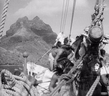 Movie still from “Tabu: A Story of the South Seas” (1931), directed by F.W. Murnau – A black and white photo of people on a boat; Wide shot, High angle