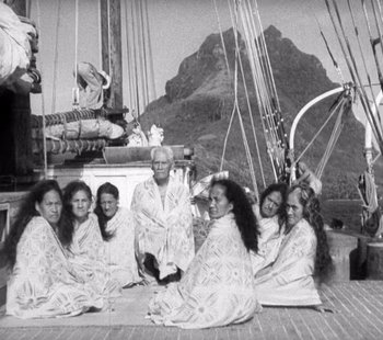 Movie still from “Tabu: A Story of the South Seas” (1931), directed by F.W. Murnau – A black and white photo of a group of women sitting on a boat; Wide shot, High angle