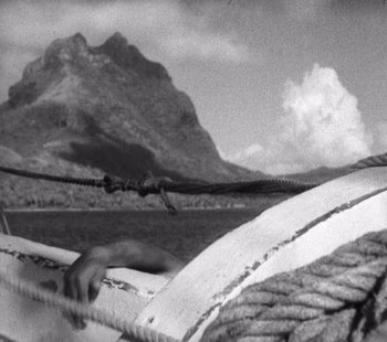 Movie still from “Tabu: A Story of the South Seas” (1931), directed by F.W. Murnau – A black - and - white photo of a boat in the water; Medium shot, High angle