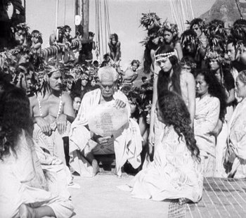 Movie still from “Tabu: A Story of the South Seas” (1931), directed by F.W. Murnau – A group of people sitting on the ground; Wide shot, High angle