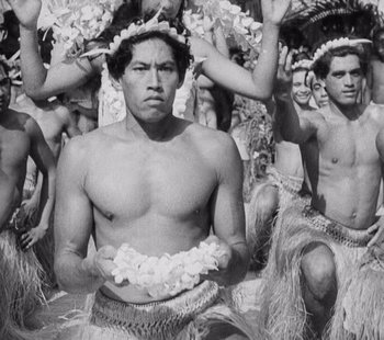 Movie still from “Tabu: A Story of the South Seas” (1931), directed by F.W. Murnau – Black and white photograph of men in hula outfits; Medium shot, Low angle