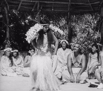 Movie still from “Tabu: A Story of the South Seas” (1931), directed by F.W. Murnau – A woman is dancing in front of a group of men; Wide shot, High angle