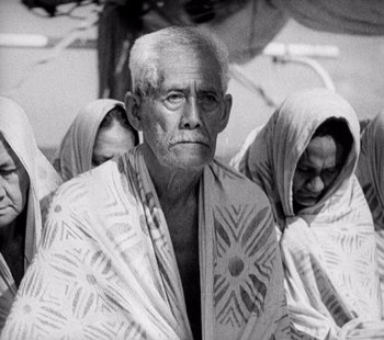 Movie still from “Tabu: A Story of the South Seas” (1931), directed by F.W. Murnau – An old man wearing a white robe and two other women; Close Up shot, Low angle