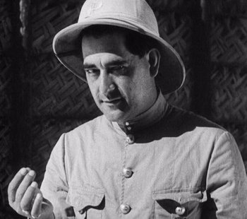Movie still from “Tabu: A Story of the South Seas” (1931), directed by F.W. Murnau – A man wearing a white hat and a shirt; Close Up shot, Over the shoulder angle