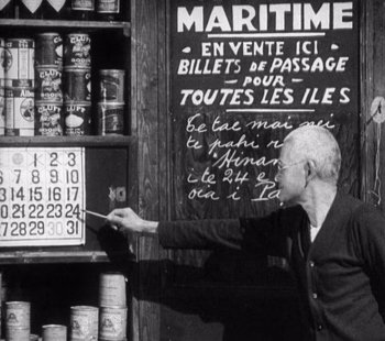 Movie still from “Tabu: A Story of the South Seas” (1931), directed by F.W. Murnau – An old man pointing to a sign in front of a store; Medium shot, Low angle