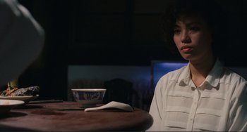 Movie still from “Taipei Story” (1985), directed by Edward Yang – A woman sitting at a table with a bowl in front of her; Close Up shot, Low angle