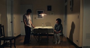 Movie still from “Taipei Story” (1985), directed by Edward Yang – A man and a woman are playing a game of ping - pong; Wide shot, High angle