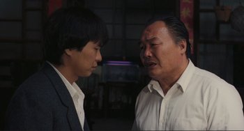 Movie still from “Taipei Story” (1985), directed by Edward Yang – A man and a boy talking to each other; Close Up shot, Over the shoulder angle