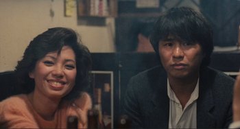 Movie still from “Taipei Story” (1985), directed by Edward Yang – A man and a woman sitting next to each other in a room; Close Up shot, Low angle
