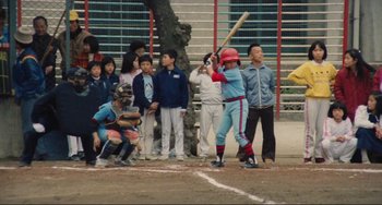 Movie still from “Taipei Story” (1985), directed by Edward Yang – A group of children watching a baseball game; Wide shot, Over the shoulder angle