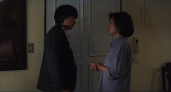Movie still from “Taipei Story” (1985), directed by Edward Yang – A man and a woman standing next to each other; Medium shot, High angle