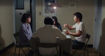 Movie still from “Taipei Story” (1985), directed by Edward Yang – A group of people sitting at a table having a conversation; Wide shot, High angle