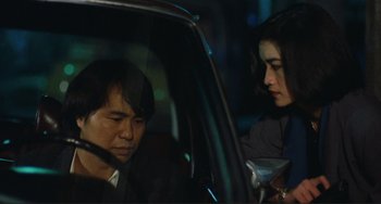 Movie still from “Taipei Story” (1985), directed by Edward Yang – A man and a woman in the back seat of a car; Close Up shot, Over the shoulder angle
