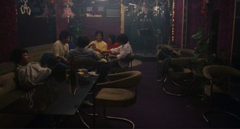 Movie still from “Taipei Story” (1985), directed by Edward Yang – A group of people sitting around a room; Wide shot, High angle