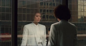 Movie still from “Taipei Story” (1985), directed by Edward Yang – A woman wearing a white suit looking into a mirror; Medium shot, Over the shoulder angle