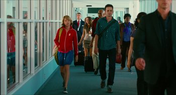 Movie still from “Take This Waltz” (2011), directed by Sarah Polley – A group of people walking down a hall way with suitcases; Wide shot, Low angle