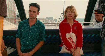 Movie still from “Take This Waltz” (2011), directed by Sarah Polley – A man and a woman sitting next to each other on a bus; Medium shot, Over the shoulder angle