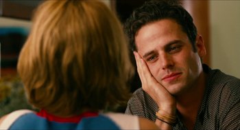 Movie still from “Take This Waltz” (2011), directed by Sarah Polley – A man sitting in front of a woman in front of a mirror; Close Up shot, Over the shoulder angle