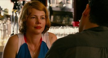 Movie still from “Take This Waltz” (2011), directed by Sarah Polley – A woman sitting in front of a man at a table; Close Up shot, Over the shoulder angle