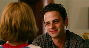 Movie still from “Take This Waltz” (2011), directed by Sarah Polley – A person sitting at a table; Close Up shot, Over the shoulder angle