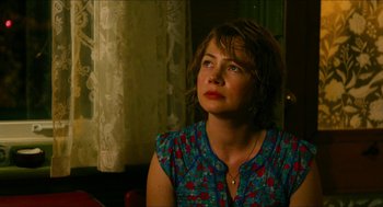 Movie still from “Take This Waltz” (2011), directed by Sarah Polley – A woman sitting in front of a window looking off to the side; Close Up shot, Over the shoulder angle
