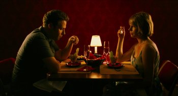Movie still from “Take This Waltz” (2011), directed by Sarah Polley – A man and a woman sitting at a dinner table; Medium shot, High angle