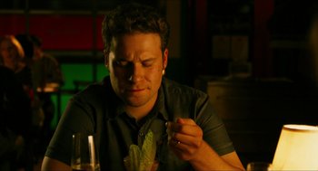 Movie still from “Take This Waltz” (2011), directed by Sarah Polley – A man sitting in front of a table eating a piece of lettuce; Close Up shot, Over the shoulder angle
