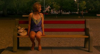 Movie still from “Take This Waltz” (2011), directed by Sarah Polley – A woman sitting on top of a wooden bench; Wide shot, High angle