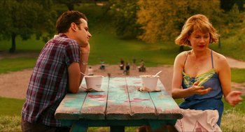 Movie still from “Take This Waltz” (2011), directed by Sarah Polley – A man and a woman sitting at a picnic table; Medium shot, Over the shoulder angle