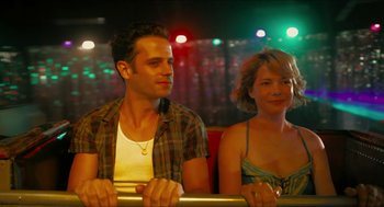 Movie still from “Take This Waltz” (2011), directed by Sarah Polley – A man and a woman sitting next to each other on a bus; Medium shot, Over the shoulder angle