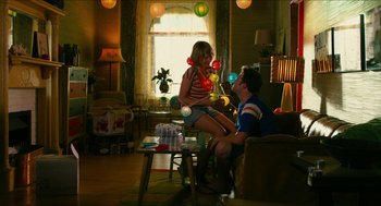 Movie still from “Take This Waltz” (2011), directed by Sarah Polley – A man and a woman sitting on a chair in front of a window; Wide shot, High angle