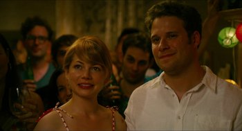 Movie still from “Take This Waltz” (2011), directed by Sarah Polley – A man and a woman standing next to each other in a crowd; Close Up shot, Over the shoulder angle