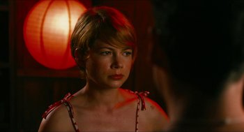 Movie still from “Take This Waltz” (2011), directed by Sarah Polley – A woman with short blonde hair wearing a red bow; Close Up shot, Over the shoulder angle