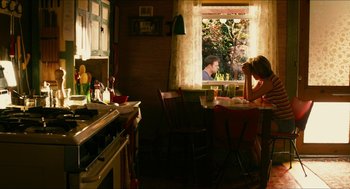 Movie still from “Take This Waltz” (2011), directed by Sarah Polley – A man and a woman sitting at a table in front of a window; Wide shot, Over the shoulder angle