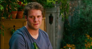 Movie still from “Take This Waltz” (2011), directed by Sarah Polley – A young man holding a beer bottle in his hand; Close Up shot, Over the shoulder angle