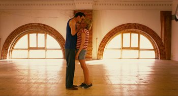 Movie still from “Take This Waltz” (2011), directed by Sarah Polley – A man and a woman kissing in a room; Wide shot, Low angle