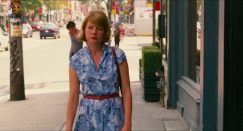 Movie still from “Take This Waltz” (2011), directed by Sarah Polley – A woman in a blue dress is walking down the street; Medium shot, Over the shoulder angle