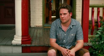Movie still from “Take This Waltz” (2011), directed by Sarah Polley – A man sitting on the porch of a house; Medium shot, Over the shoulder angle