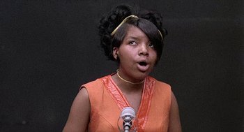 Movie still from “Taking Off” (1971), directed by Milos Forman – A young woman with a surprised look on her face; Close Up shot, Low angle