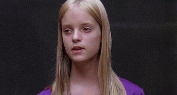 Movie still from “Taking Off” (1971), directed by Milos Forman – A young girl with long blonde hair wearing a purple shirt; Close Up shot, Low angle