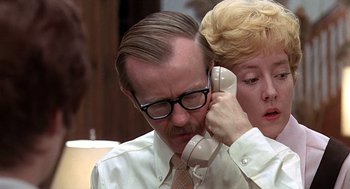 Movie still from “Taking Off” (1971), directed by Milos Forman – A man and a woman are talking on a phone; Close Up shot, Low angle