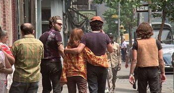 Movie still from “Taking Off” (1971), directed by Milos Forman – A group of people walking down a street; Medium shot, Over the shoulder angle