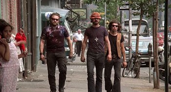 Movie still from “Taking Off” (1971), directed by Milos Forman – A group of men walking down a street; Medium shot, Low angle