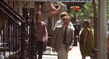 Movie still from “Taking Off” (1971), directed by Milos Forman – A group of people walking down a street; Medium shot, Low angle