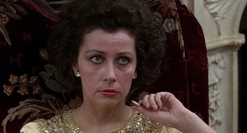 Movie still from “Taking Off” (1971), directed by Milos Forman – A person holding a pen in their hand; Close Up shot, Over the shoulder angle