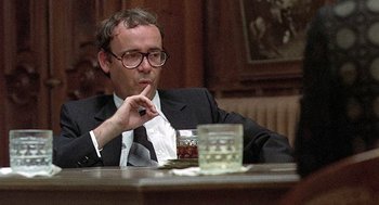 Movie still from “Taking Off” (1971), directed by Milos Forman – A man sitting at a table with a glass of whiskey; Close Up shot, Over the shoulder angle