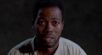 Movie still from “Tales from the Hood” (1995), directed by Rusty Cundieff – A person wearing a white shirt; Close Up shot, Low angle