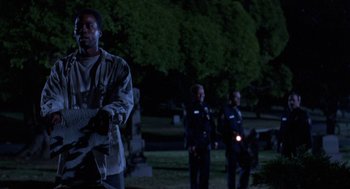Movie still from “Tales from the Hood” (1995), directed by Rusty Cundieff – A group of men standing next to each other in the dark; Medium shot, Low angle