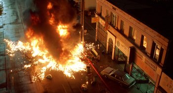 Movie still from “Tales from the Hood” (1995), directed by Rusty Cundieff – An image of a fire that is burning on the street; Extreme Wide shot, Overhead angle