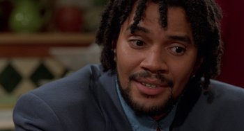 Movie still from “Tales from the Hood” (1995), directed by Rusty Cundieff – A person wearing a suit and tie; Close Up shot, Low angle